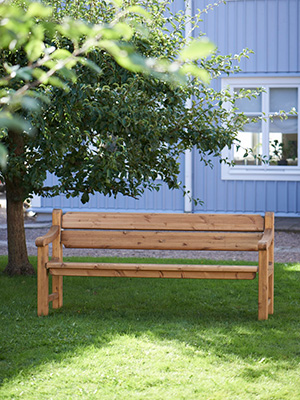 All wood bench, very traditional with arm and backrest.